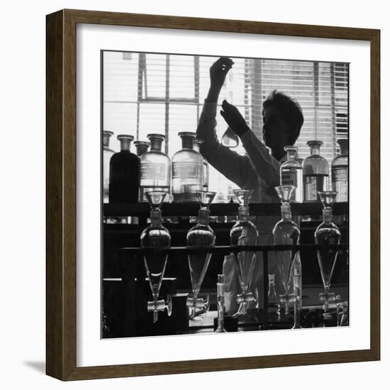 A Chemist at Work in Her Laboratory-Henry Grant-Framed Photographic Print