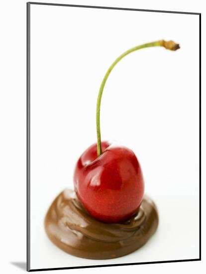 A Cherry on a Blob of Chocolate Sauce-Greg Elms-Mounted Photographic Print