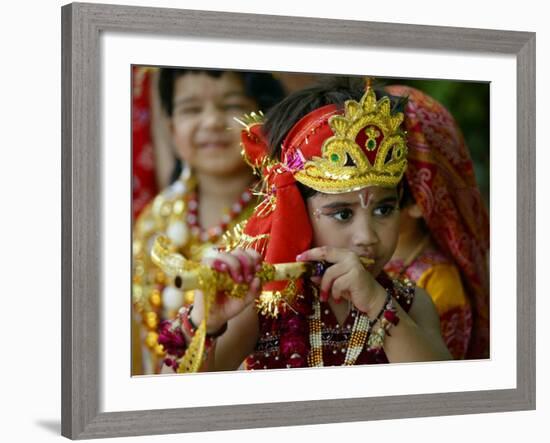 A Child Enacts the Life of Hindu God Krishna During Janamashtami Celebrations-null-Framed Photographic Print