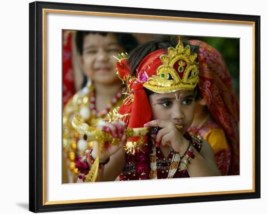 A Child Enacts the Life of Hindu God Krishna During Janamashtami Celebrations-null-Framed Photographic Print