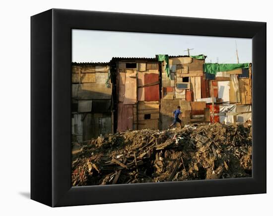 A Child Runs by a Row of Shacks in Novo Mundo Shantytown, Sao Paulo, Brazil-null-Framed Premier Image Canvas