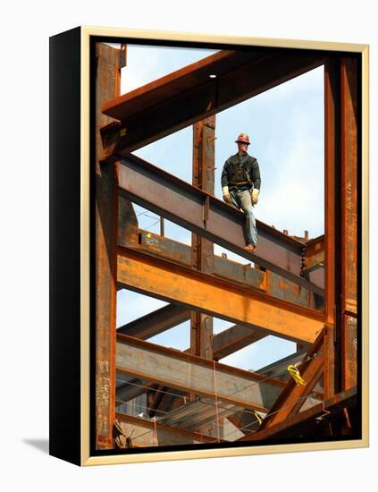 A Construction Worker Stands on a Steel Beam While Working on a High Rise Building-null-Framed Premier Image Canvas