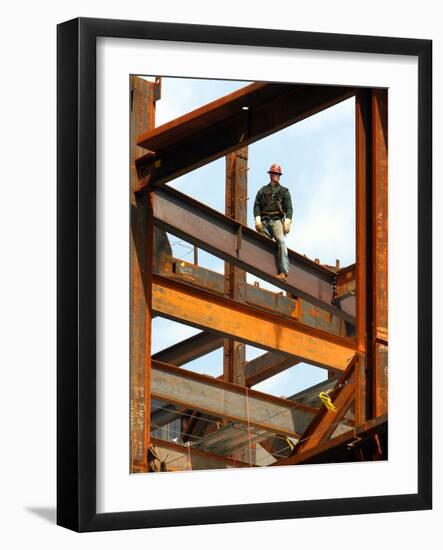 A Construction Worker Stands on a Steel Beam While Working on a High Rise Building-null-Framed Photographic Print