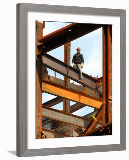 A Construction Worker Stands on a Steel Beam While Working on a High Rise Building-null-Framed Photographic Print