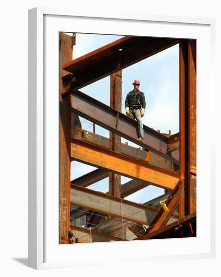 A Construction Worker Stands on a Steel Beam While Working on a High Rise Building--Framed Photographic Print