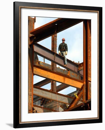 A Construction Worker Stands on a Steel Beam While Working on a High Rise Building-null-Framed Photographic Print