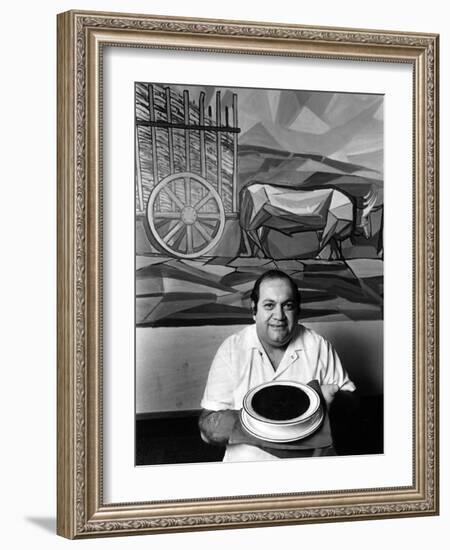 A Cook Holds a Bowl of Cuban Style Black Beans at La Carreta Restaurant, 1987-null-Framed Photographic Print