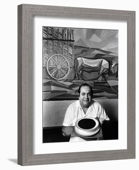 A Cook Holds a Bowl of Cuban Style Black Beans at La Carreta Restaurant, 1987-null-Framed Photographic Print