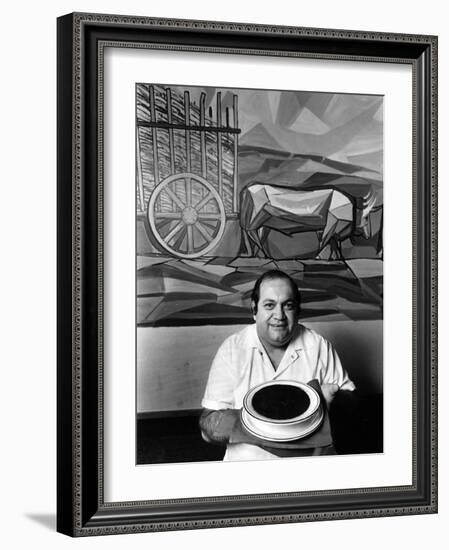 A Cook Holds a Bowl of Cuban Style Black Beans at La Carreta Restaurant, 1987-null-Framed Photographic Print