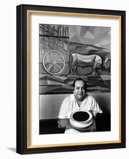 A Cook Holds a Bowl of Cuban Style Black Beans at La Carreta Restaurant, 1987-null-Framed Photographic Print