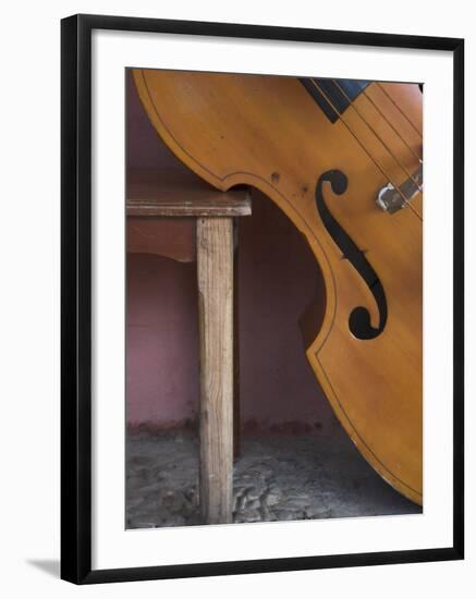 A Counterbass Leaning Against a Wooden Table, Trinidad, Sancti Spiritus Province, West Indies-Eitan Simanor-Framed Photographic Print