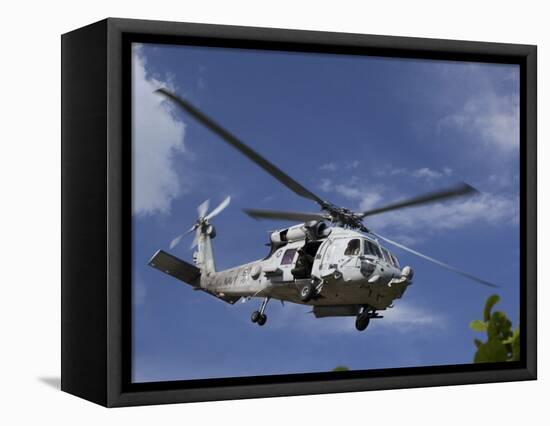 A Crew Chief Looks Out the Side Door of a Helicopter in Flight-null-Framed Premier Image Canvas