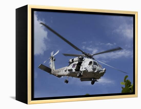 A Crew Chief Looks Out the Side Door of a Helicopter in Flight-null-Framed Premier Image Canvas