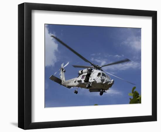 A Crew Chief Looks Out the Side Door of a Helicopter in Flight-null-Framed Photographic Print