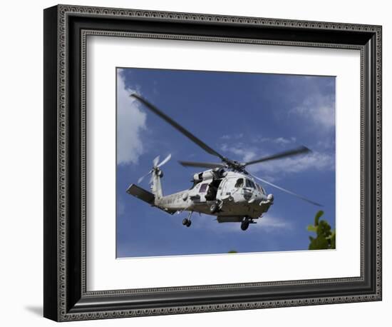 A Crew Chief Looks Out the Side Door of a Helicopter in Flight-null-Framed Photographic Print