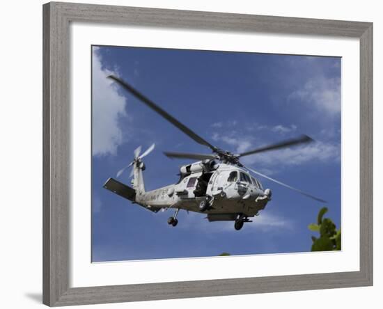 A Crew Chief Looks Out the Side Door of a Helicopter in Flight-null-Framed Photographic Print