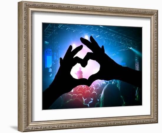 A Crowd of People at a Concert with a Heart Shaped Hand Shadow-graphicphoto-Framed Photographic Print