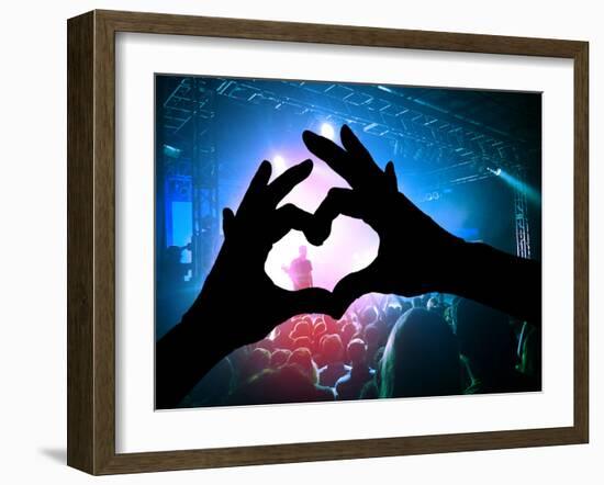 A Crowd of People at a Concert with a Heart Shaped Hand Shadow-graphicphoto-Framed Photographic Print