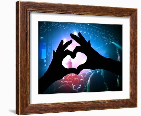 A Crowd of People at a Concert with a Heart Shaped Hand Shadow-graphicphoto-Framed Photographic Print