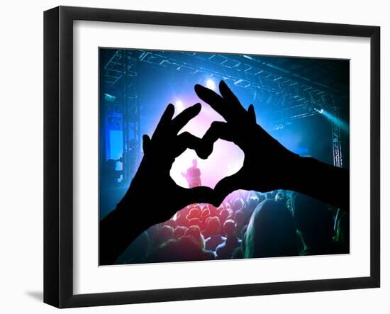 A Crowd of People at a Concert with a Heart Shaped Hand Shadow-graphicphoto-Framed Photographic Print