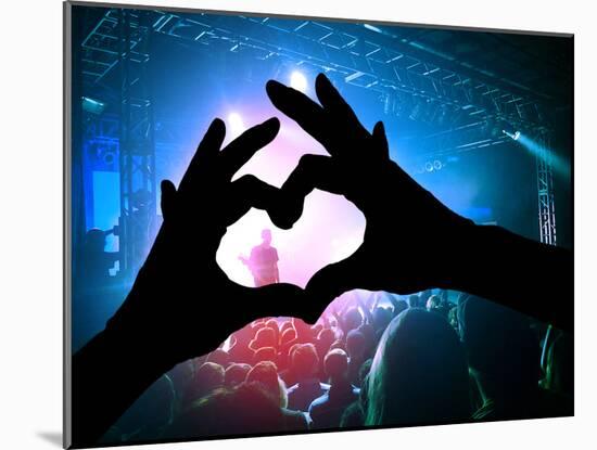 A Crowd of People at a Concert with a Heart Shaped Hand Shadow-graphicphoto-Mounted Photographic Print