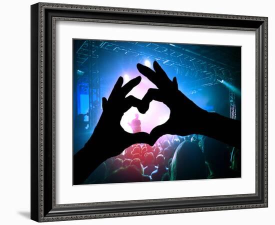 A Crowd of People at a Concert with a Heart Shaped Hand Shadow-graphicphoto-Framed Photographic Print