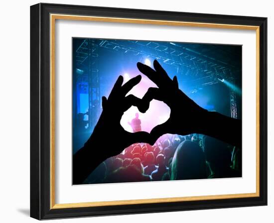 A Crowd of People at a Concert with a Heart Shaped Hand Shadow-graphicphoto-Framed Photographic Print