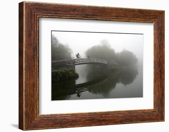 A cyclist on a bridge on Birmingham Canal Navigations (BCN), Birmingham, West Midlands, England, Un-Graham Lawrence-Framed Photographic Print