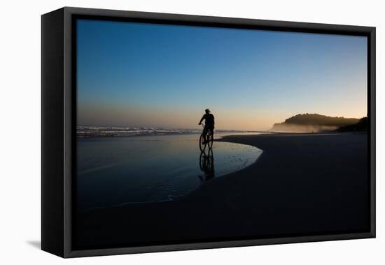 A Cyclist on Juquehy Beach at Sunset-Alex Saberi-Framed Premier Image Canvas