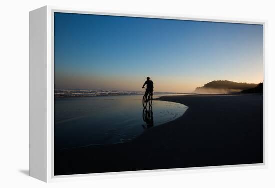 A Cyclist on Juquehy Beach at Sunset-Alex Saberi-Framed Premier Image Canvas