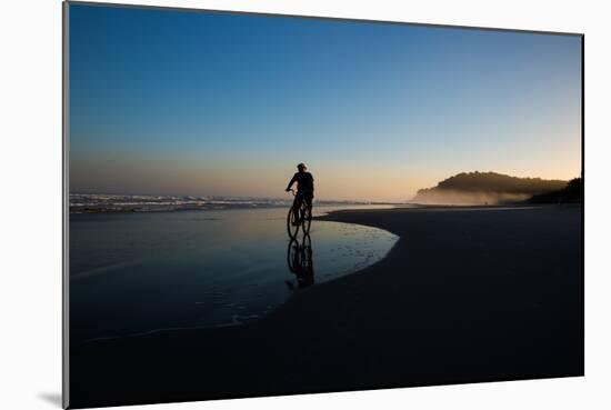 A Cyclist on Juquehy Beach at Sunset-Alex Saberi-Mounted Photographic Print