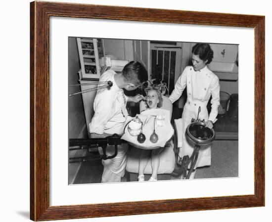 A Dentist Examining a Young Girl's Teeth in 1942-null-Framed Photo