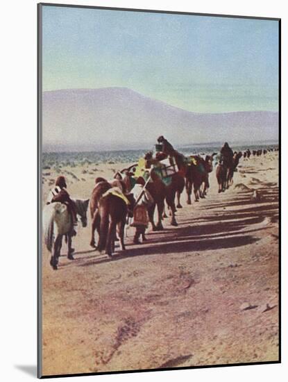 A Desert Camel Caravan - Peking to Russian Turkestan-Ella K. Maillart-Mounted Art Print