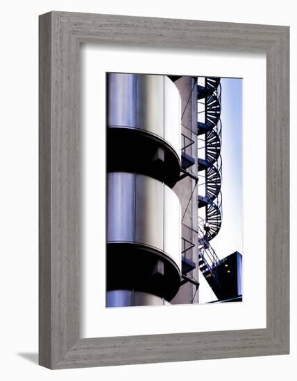 A detail of Lloyds London headquarters building shows metal clad cylinders and spiral staircase-Charles Bowman-Framed Photographic Print