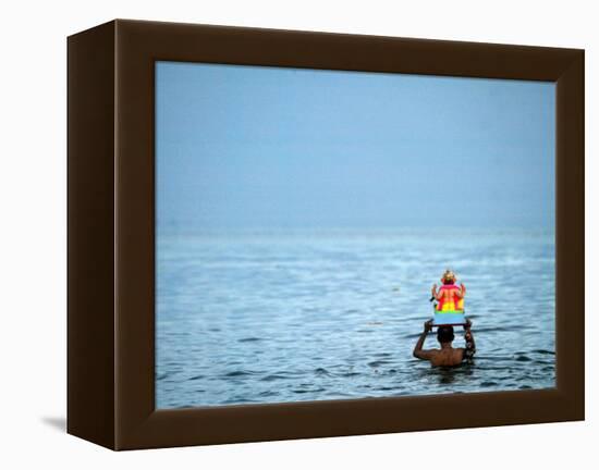 A Devotee Immerses the Idol of Elephant-Headed Hindu God Ganesh-null-Framed Premier Image Canvas