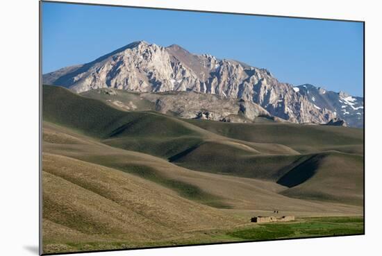 A Distant House in the Grasslands with Views of Mountains in the Distance, Bamiyan Province-Alex Treadway-Mounted Photographic Print