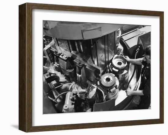 A Factory Worker Operates a Ryder Disc Brake Pad Machine. Photograph by Heinz Zinram-Heinz Zinram-Framed Photographic Print