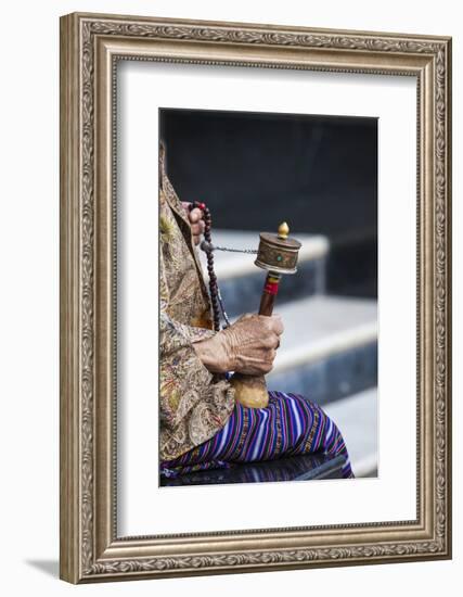 A Faithful Buddhist Uses the Traditional Portable Roller-Book (Prayer Wheel), Bhutan-Roberto Moiola-Framed Photographic Print