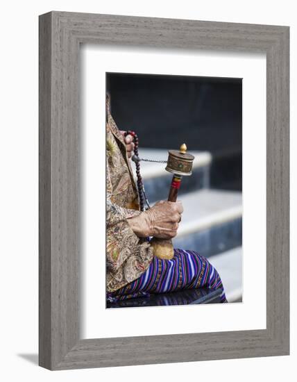 A Faithful Buddhist Uses the Traditional Portable Roller-Book (Prayer Wheel), Bhutan-Roberto Moiola-Framed Photographic Print