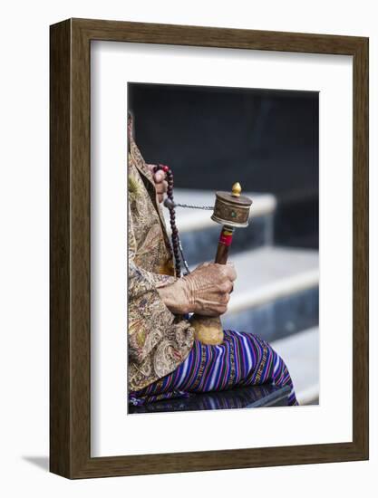 A Faithful Buddhist Uses the Traditional Portable Roller-Book (Prayer Wheel), Bhutan-Roberto Moiola-Framed Photographic Print