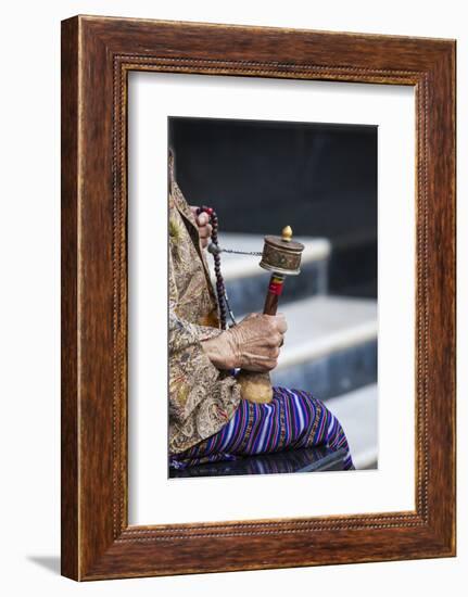 A Faithful Buddhist Uses the Traditional Portable Roller-Book (Prayer Wheel), Bhutan-Roberto Moiola-Framed Photographic Print