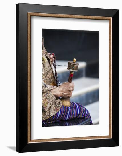 A Faithful Buddhist Uses the Traditional Portable Roller-Book (Prayer Wheel), Bhutan-Roberto Moiola-Framed Photographic Print