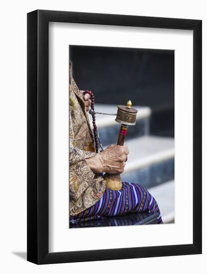 A Faithful Buddhist Uses the Traditional Portable Roller-Book (Prayer Wheel), Bhutan-Roberto Moiola-Framed Photographic Print