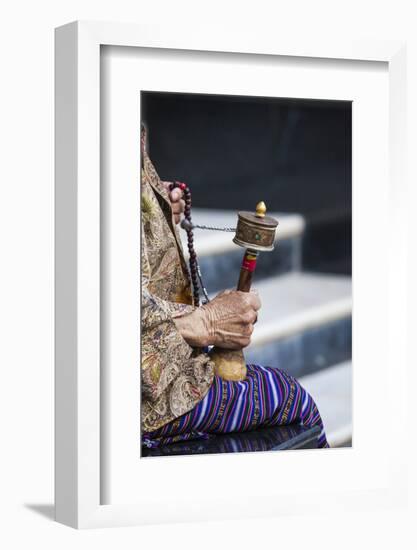 A Faithful Buddhist Uses the Traditional Portable Roller-Book (Prayer Wheel), Bhutan-Roberto Moiola-Framed Photographic Print