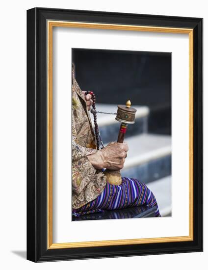 A Faithful Buddhist Uses the Traditional Portable Roller-Book (Prayer Wheel), Bhutan-Roberto Moiola-Framed Photographic Print