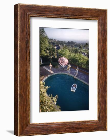 A Family at their Backyard Swimming Pool, in Foreground a Floating Rowboat with Boy Aboard-Frank Scherschel-Framed Photographic Print