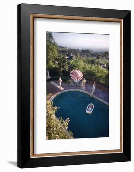 A Family at their Backyard Swimming Pool, in Foreground a Floating Rowboat with Boy Aboard-Frank Scherschel-Framed Photographic Print