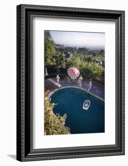 A Family at their Backyard Swimming Pool, in Foreground a Floating Rowboat with Boy Aboard-Frank Scherschel-Framed Photographic Print