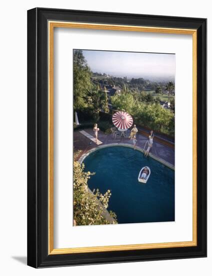 A Family at their Backyard Swimming Pool, in Foreground a Floating Rowboat with Boy Aboard-Frank Scherschel-Framed Photographic Print