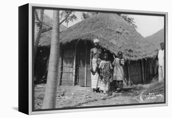 A Family in Front of their Home, Gambia, 20th Century-null-Framed Premier Image Canvas